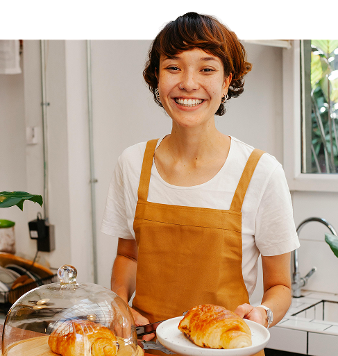 Smiling lady in apron in a kitchen setting